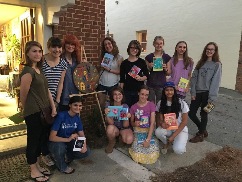 A group of young woman with their artworks
